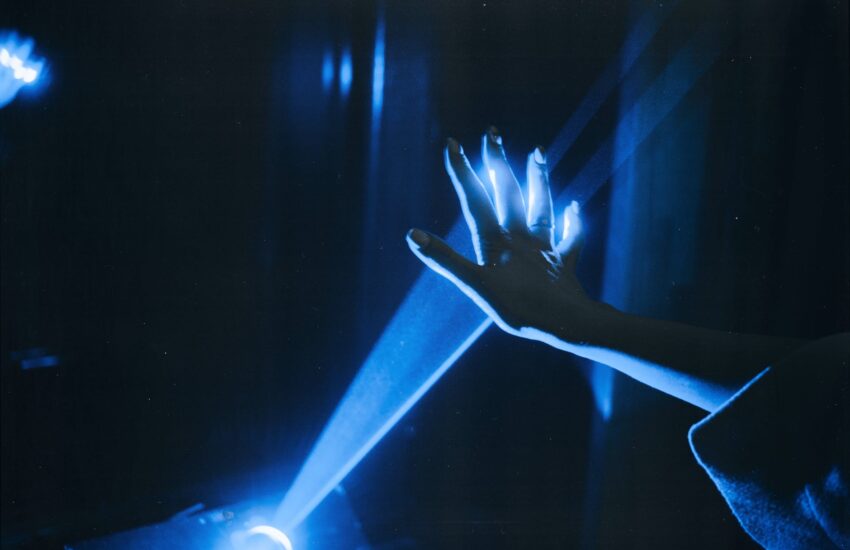 photo of person s hand with blue light