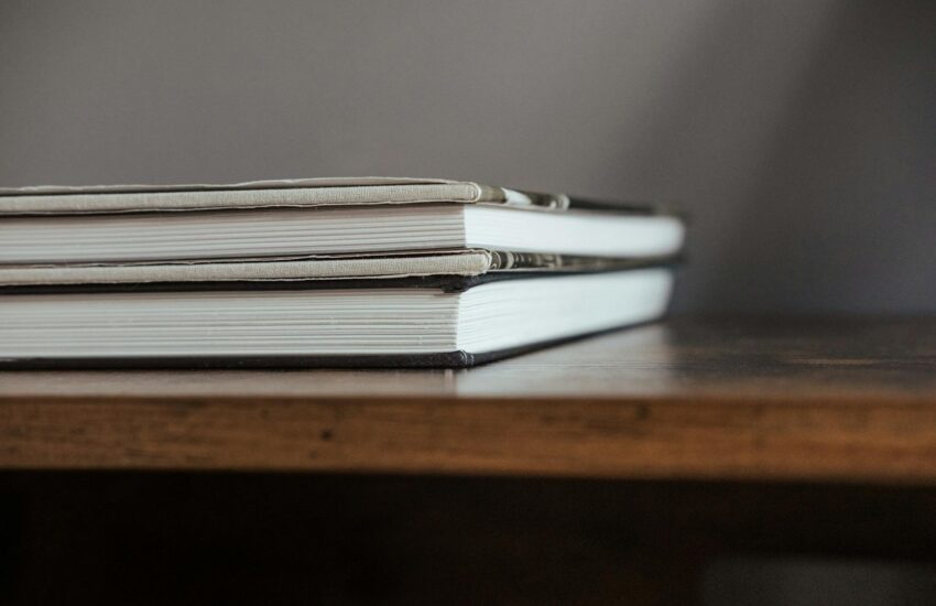 stack of textbooks on wooden table