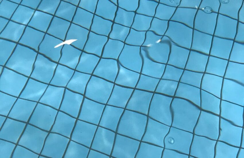 swimming pool with water and blue bottom