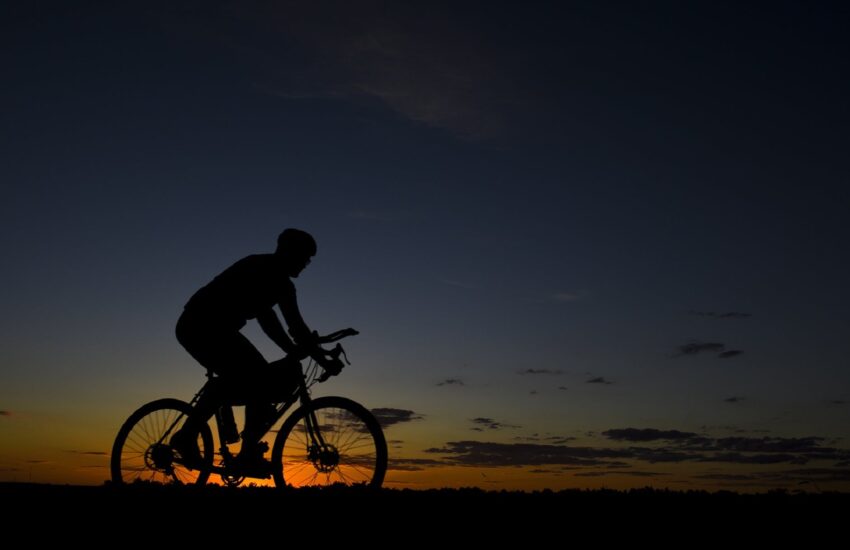 man riding bicycle during nightfall