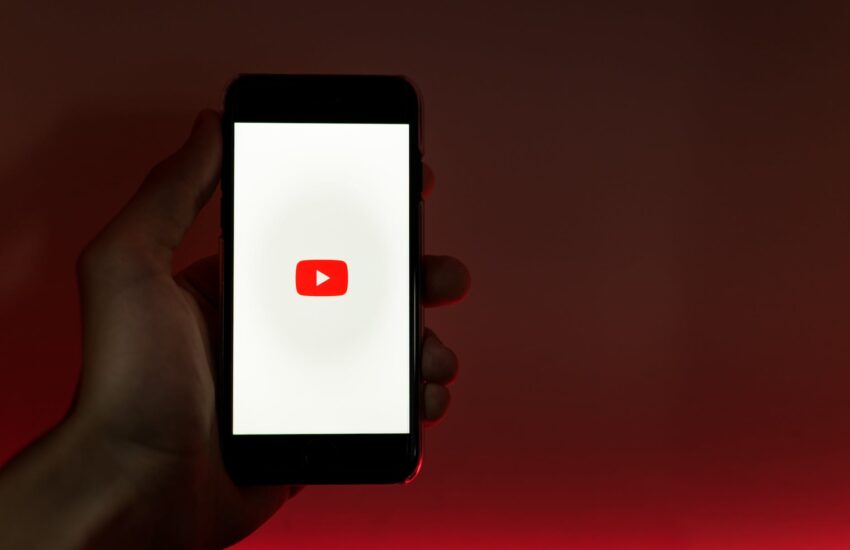 hand holding smartphone with internet access to youtube