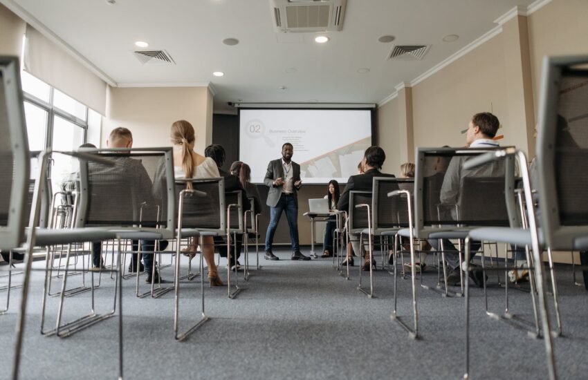 a man standing near a projector screen