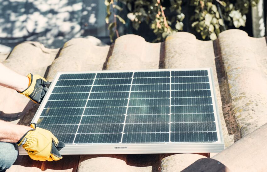 black solar panel on brown roof tiles